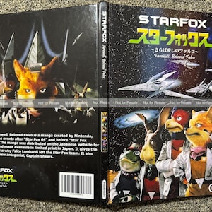 May include: A Star Fox: Farewell, Beloved Falco manga book cover featuring a black background with space imagery, white text, and illustrations of anthropomorphic characters including a fox, bird, and frog in silver jackets, with a barcode.