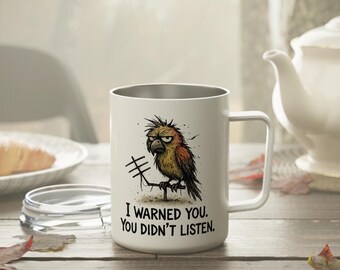 May include: White stainless steel travel mug with a cartoon bird illustration and the text "I warned you. You didn't listen."