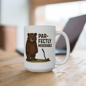 May include: White ceramic coffee mug with a brown bear illustration and the text "PAR-FECTLY MISERABLE".