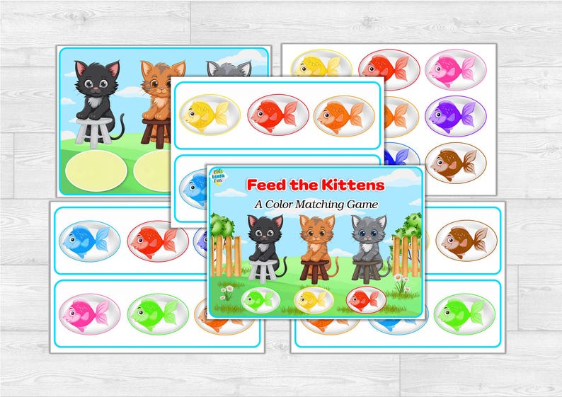 Puede incluir: Un juego de emparejamiento de colores para ni&ntilde;os titulado "Alimenta a los gatitos". El juego presenta ilustraciones de gatitos y peces de colores. Las tarjetas del juego est&aacute;n dispuestas sobre una superficie de vetas de madera clara.