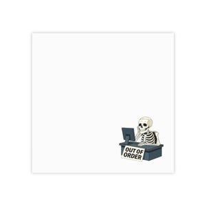 May include: A cartoon illustration of a white skeleton sitting at a dark blue desk with a computer monitor. The skeleton is holding a phone to its ear. A white sign attached to the front of the desk features the black text OUT OF ORDER.