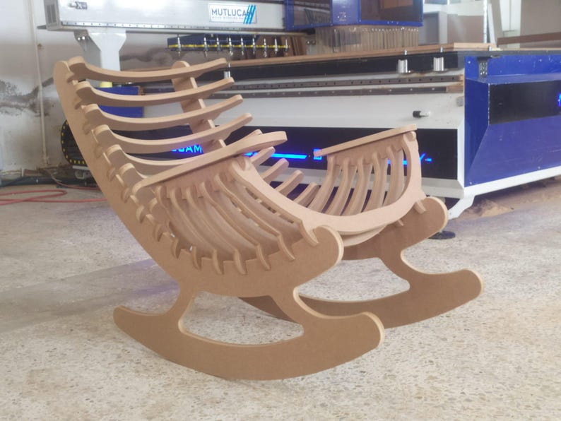 May include: A wooden rocking chair with a unique, open design. The chair is constructed from light brown wood and features a curved seat and backrest with multiple vertical slats. The rocker has a modern, minimalist aesthetic.