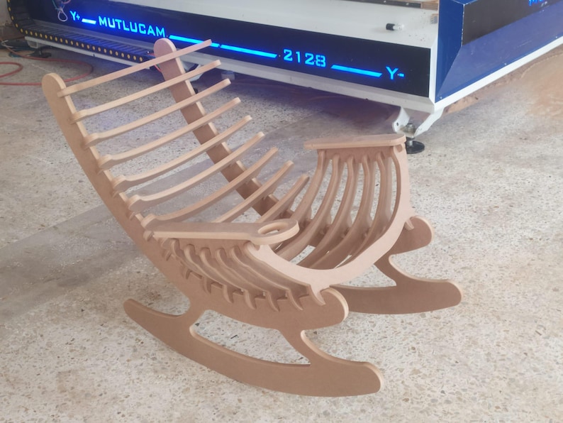 May include: A light brown wooden rocking chair with a curved back and seat. The chair has a slatted backrest and a curved seat. The chair is made of wood and has a natural finish. The chair is designed for comfort and relaxation.