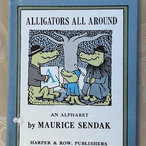 May include: A vintage children's book titled "Alligators All Around" by Maurice Sendak. The cover features an illustration of three anthropomorphic alligators, one holding a sign with the letter "A". The book is published by Harper & Row.