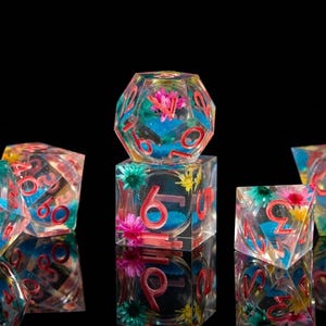 May include: A white ceramic mug with a black handle and the text "But First, Coffee" in a black, handwritten-style font. The mug is on a white surface.