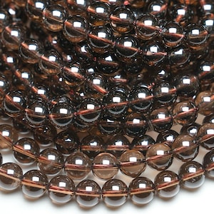 Peut inclure: Un brin de perles de quartz fumé brun foncé. Les perles sont rondes et ont une finition lisse et polie.