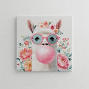 May include: Square canvas art depicting a white llama wearing pink sunglasses and blowing a large pink bubble. The llama has a floral crown and is surrounded by colorful flowers, creating a whimsical and cheerful design.