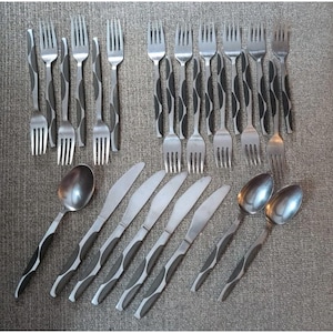 May include: A collection of stainless steel cutlery, comprising forks, knives, and spoons. The handles feature a black and grey wavy pattern. The forks and spoons have a rounded bowl, and the knives have a smooth blade.