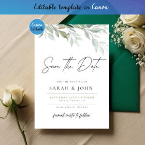 May include: A white Save the Date wedding invitation card featuring watercolor green leaves at the top. The text reads Save The Date, For the wedding of Sarah & John, Saturday 22nd October, Twenty Twenty six, 123 Anywhere St., Any City, formal invite to follow.