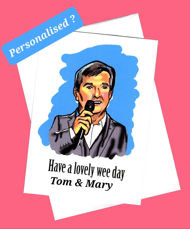 May include: A white card with a blue background and a cartoon drawing of a man holding a microphone. The text "Have a lovely wee day Tom & Mary" is printed on the card.