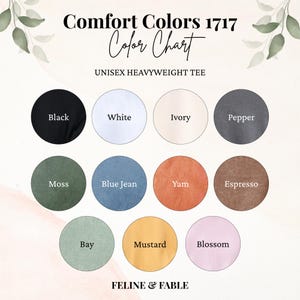May include: Color chart for Comfort Colors 1717 unisex heavyweight tees. The chart displays a range of colors, including black, white, ivory, pepper, moss, blue jean, yam, espresso, bay, mustard, and blossom. The brand name "FELINE & FABLE" is at the bottom.