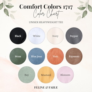 May include: A colour chart for Comfort Colors 1717 unisex heavyweight tees. The chart shows various colours: black, white, ivory, pepper, moss, blue jean, yam, espresso, bay, mustard, and blossom. The brand name "FELINE & FABLE" is at the bottom.