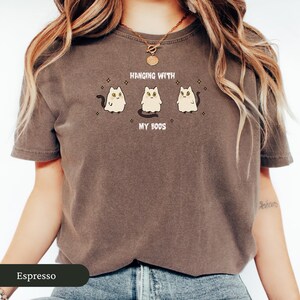 May include: Espresso-coloured t-shirt with the text "Hanging with my Boos" and three cartoon ghost cats. The cats have black tails and are surrounded by star shapes. A casual, unisex style t-shirt.
