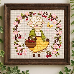 May include: A white ceramic mug with a black handle and the text "But First, Coffee" in a bold, black font. The mug is set against a blurred background, suggesting a cosy setting.