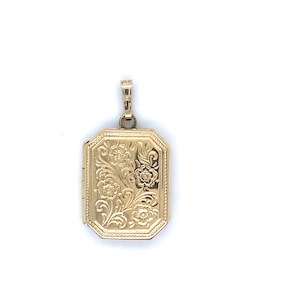 May include: A rectangular gold locket pendant with an octagonal shape, featuring an intricate embossed floral pattern on the front surface and a small, textured bail at the top for attachment to a chain or necklace.