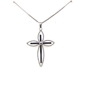 May include: A silver chain necklace with a black and silver cross pendant. The cross is made of small beads and has a round center.
