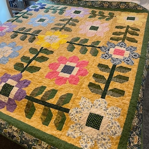 Spring Flowers: een unieke, handgemaakte gewatteerde deken met patchwork