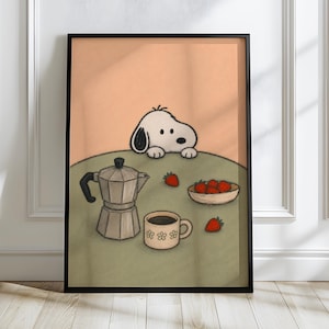 May include: A framed wall art print featuring a cartoon white dog with black ears peering over a green table. On the table sits a silver moka pot, a beige mug with white flower patterns, and a small bowl filled with red strawberries.