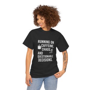 May include: A black t-shirt with white text that reads "Running on Caffeine, Chaos, and Questionable Decisions." A coffee cup icon and lightning bolt are included in the text.