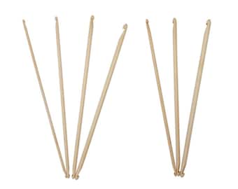 May include: A set of eight wooden crochet hooks of varying sizes. The hooks are arranged in two groups of four, with the tips of the hooks pointing towards the center of the image.