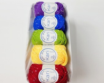 May include: Five balls of yarn in a rainbow of colors, purple, blue, green, yellow, and red. Each ball has a white label with the words "Chet Kari Flecks" printed on it.