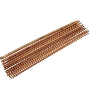 May include: A set of 12 bamboo knitting needles in various sizes. The needles are arranged in a fan shape, with the largest needle at the top and the smallest needle at the bottom.