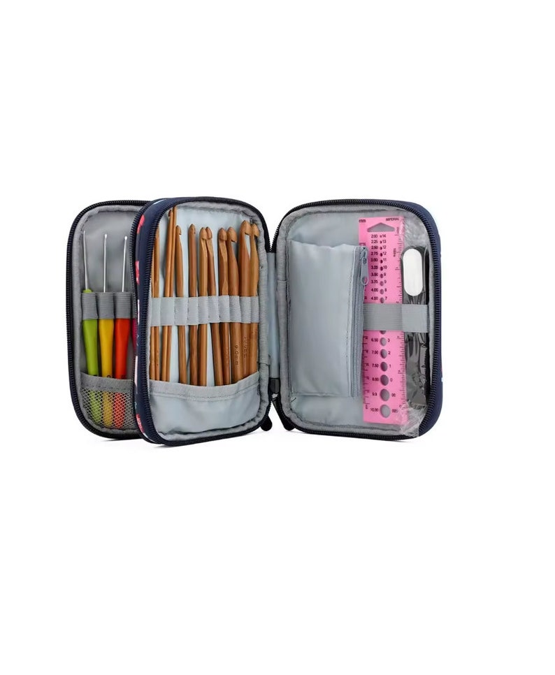 May include: A navy blue zippered case with a floral pattern, open to reveal a variety of crochet hooks, knitting needles, and a pink ruler with measurement markings.