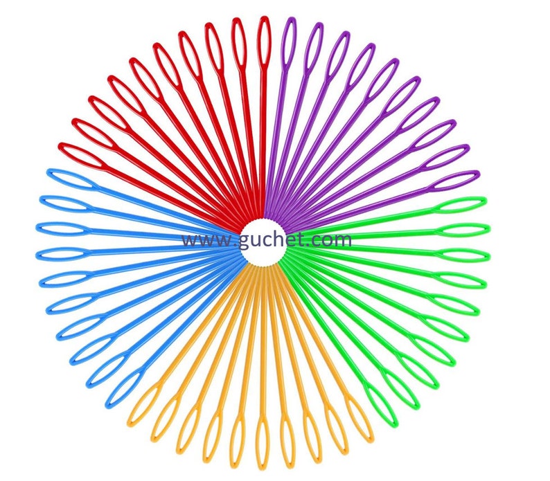 May include: A set of 50 colourful plastic needles arranged in a circle. The needles are red, purple, green, blue, and yellow. The needles are all the same size and have a small loop at the end. The needles are used for crocheting.