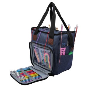 May include: A blue canvas tote bag with multiple pockets and compartments for storing knitting needles and other supplies. The bag has a zipper closure and a top handle.