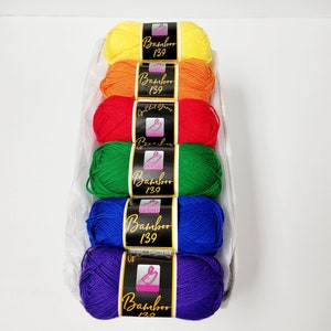 May include: Six skeins of yarn in a rainbow of colors, yellow, orange, red, green, blue, and purple. Each skein is labeled "Bamboo 139" with a pink crochet hook logo.