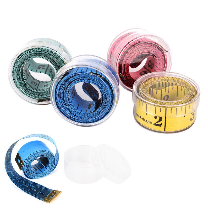 May include: Four retractable measuring tapes in clear plastic cases. The tapes are yellow, blue, green, and pink. The yellow tape has the text "fiber-glass" printed on it.