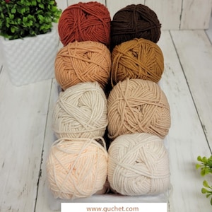 May include: A set of eight balls of yarn in various shades of brown, beige, and peach. The yarn is arranged in a row, with the darkest shade at the top and the lightest shade at the bottom. The yarn is labeled "Skin Tone Palette" and "www.guchet.com".