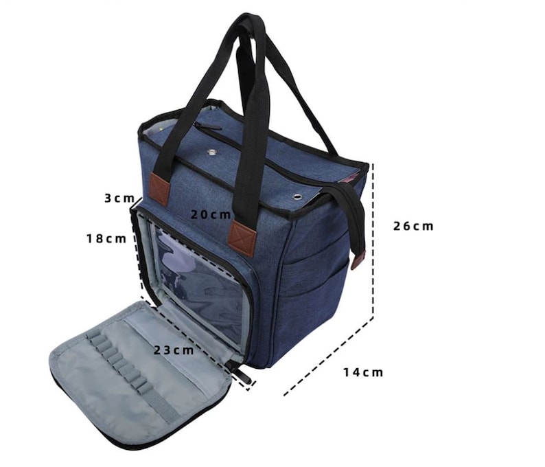 May include: A blue canvas tote bag with a zippered top and a clear plastic window. The bag has a handle and a shoulder strap. The bag measures 26 cm tall, 20 cm wide, and 14 cm deep.