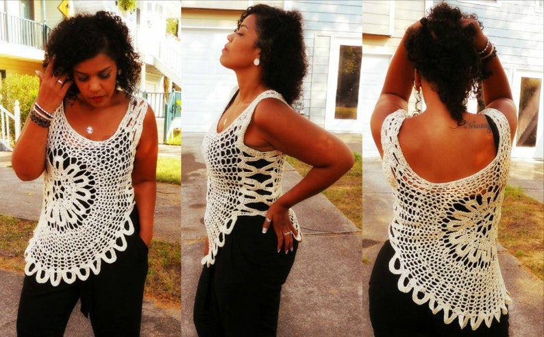 May include: A white crochet top with a scalloped hem and a floral design. The top is sleeveless and has a loose fit.