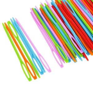 May include: A close-up of a bundle of colourful plastic needles. The needles are arranged in a fan shape and are all the same size. The needles are a variety of colours, including red, orange, yellow, green, blue, and purple.
