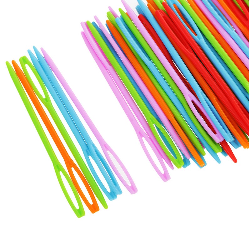 May include: A close-up of a bundle of colourful plastic needles. The needles are arranged in a fan shape and are all the same size. The needles are a variety of colours, including red, orange, yellow, green, blue, and purple.