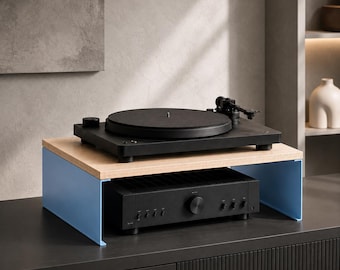 May include: A light blue metal stand with a light wood top surface. A black turntable sits on the top of the stand, while a black audio amplifier with multiple knobs and a central volume dial is positioned underneath the wooden shelf.