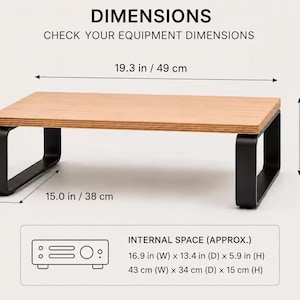 May include: A rectangular monitor stand with a light wood grain top and black metal legs. Text reads: DIMENSIONS, CHECK YOUR EQUIPMENT DIMENSIONS, 19.3 in / 49 cm, 6.5 in / 16.5 cm, 15.0 in / 38 cm, INTERNAL SPACE (APPROX.) 16.9 in (W) x 13.4 in (D) x 5.9 in (H).