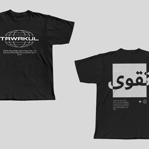 May include: Two black t-shirts with white text and graphics. The first shirt has a globe graphic and the text "TAWAKUL" and "Plans may break, dreams may fade, but the one who holds the outcome never gives". The second shirt has the Arabic word "Tawakkul" in a white square with a small globe graphic below it. The text below the graphic reads "Taking a leap then fearlessly, we are wrapped in surrender. It guides the tongue, gathers the tears, and softens the soul."