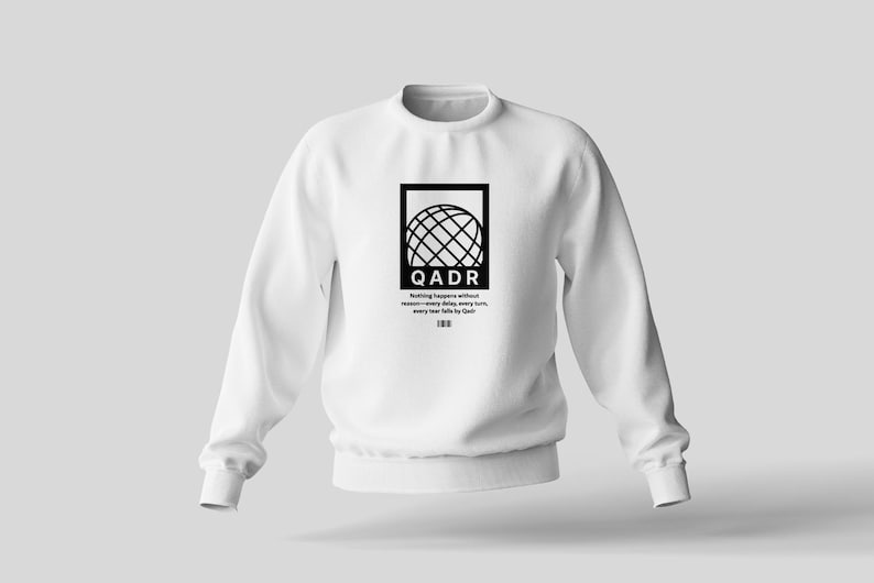 May include: White sweatshirt with a black graphic of a globe and the text "QADR" and the phrase "Nothing happens without reason, every day is a new turn, every year falls by Qadr".