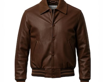 May include: A brown leather jacket with a button-up front, a collar, and ribbed cuffs and hem. The jacket has two front pockets and a brown lining. The jacket is a classic style.