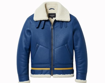 May include: A blue aviator jacket with a cream-colored shearling collar and lining. The jacket features a zip-up front, two front pockets, and yellow stripes on the bottom hem. The jacket has a classic, vintage style.