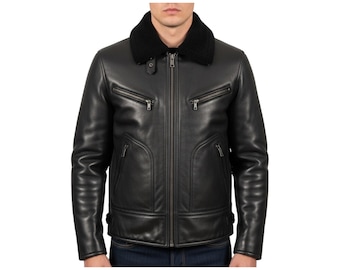 May include: A black leather jacket featuring a black faux fur collar, a central metal zipper closure, and two horizontal zippered chest pockets. The jacket includes two lower side pockets with curved seams and adjustable side waist straps.
