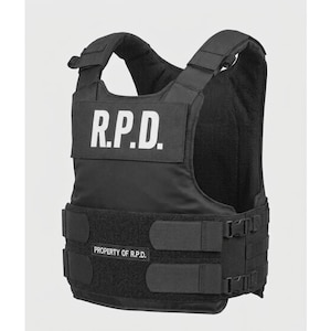 May include: Black tactical vest with the text "R.P.D." in white block letters on the chest. The vest has adjustable straps, buckles, and a lower panel with the text "PROPERTY OF R.P.D."
