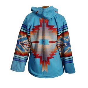 May include: A turquoise hooded jacket with a Southwestern-inspired design on the back and sleeves. The pattern features geometric shapes in shades of red, orange, blue, and beige. The jacket has a full-length zipper and a hood.