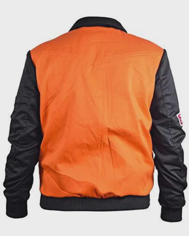 May include: Back view of a bomber jacket. The jacket features a bright orange body with black sleeves and a black collar. The jacket has a ribbed hem and cuffs. A small white patch with red text is on the left sleeve.