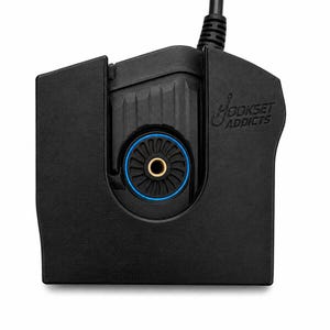 May include: A black plastic device with a cord extending from the top. The front features a circular blue-rimmed vent with a brass-coloured centre. The text HOOKSET ADDICTS is embossed on the upper right side of the matte black housing.
