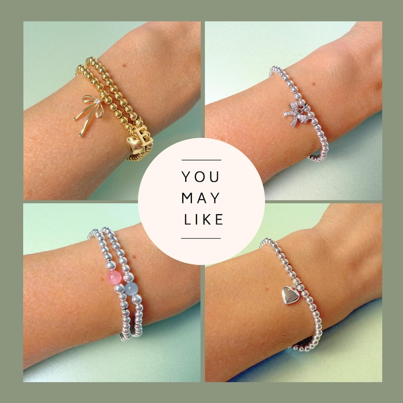 May include: Four bracelets are displayed, each worn on a wrist. One is gold with a bow charm, another silver with a bow charm, a third silver with pink and blue beads, and the last silver with a heart charm. The text "YOU MAY LIKE" is in the center.