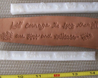 May include: Three white rubber stamps with raised lettering and designs. The stamps are for leather crafting and feature the words "Courage is fear that are time and patience... XOXO" and a horseshoe design.