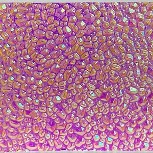 May include: A sheet of iridescent holographic vinyl with a textured, raised, diamond-like pattern. The vinyl is a mix of pink, purple, and gold colors.